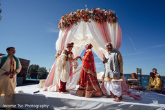 Indian bride and groom under the beautiful mandap Indian bride and groom under the beautiful mandap