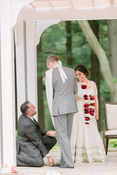 Indian groom and bride touches with toe seven nuts or betel. Indian groom and bride touches with toe seven nuts or betel.