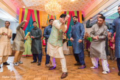 Indian groom having a blast during the pre wedding dance Indian groom having a blast during the pre wedding dance