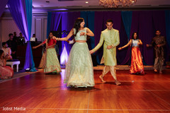 Indian couple dancing during sangeet Indian couple dancing during sangeet