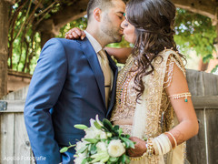 Indian bride and groom kissing during the photo shoot Indian bride and groom kissing during the photo shoot