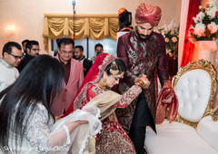 Sweet indian groom helping his bride to be Sweet indian groom helping his bride to be