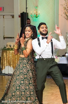 Indian newlyweds performing at the reception Indian newlyweds performing at the reception