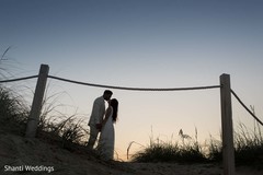 Indian groom and maharani posing during sunset Indian groom and maharani posing during sunset