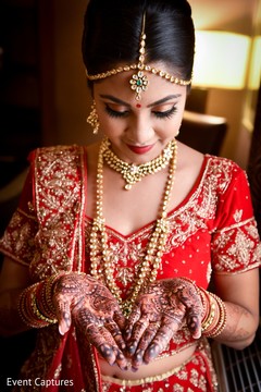 Cute Indian bride admiring her mehndi art. Cute Indian bride admiring her mehndi art.