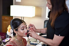 Indian bride getting her makeup done. Indian bride getting her makeup done.