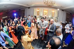 Cheerful Indian wedding guests rocking the dance floor Cheerful Indian wedding guests rocking the dance floor