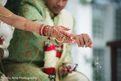 Indian bride and groom throwing the rice to sacred fire. Indian bride and groom throwing the rice to sacred fire.