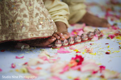 Indian bride and groom rolling betel nut with toes. Indian bride and groom rolling betel nut with toes.