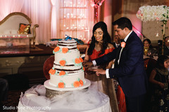 Indian wedding cutting the cake scene. Indian wedding cutting the cake scene.