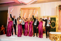 Indian bridesmaids and groomsmen cheering during the reception Indian bridesmaids and groomsmen cheering during the reception