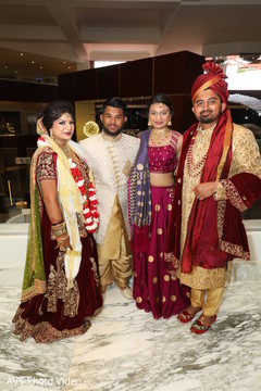 Glamorous Indian bride and groom with guests portrait. Glamorous Indian bride and groom with guests portrait.