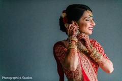 Dazzling Indian bride putting her earrings on. Dazzling Indian bride putting her earrings on.