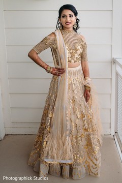 Dreamy Indian bride on her reception outfit in an outdoors portrait. Dreamy Indian bride on her reception outfit in an outdoors portrait.