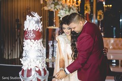 Indian bride and groom cutting the cake Indian bride and groom cutting the cake