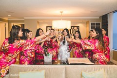 Indian bride makes a toast with the bridesmaids Indian bride makes a toast with the bridesmaids