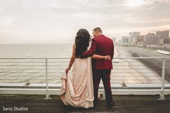 Indian newlyweds staring at the ocean after the ceremony Indian newlyweds staring at the ocean after the ceremony