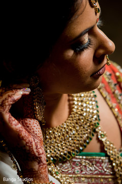 Indian bride putting earrings on. Indian bride putting earrings on.