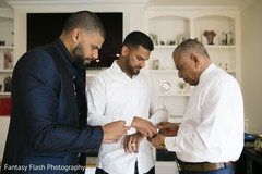 Indian groom fixing his shirt. Indian groom fixing his shirt.