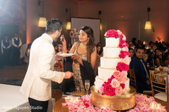 Indian lovebirds sharing a slice of cake Indian lovebirds sharing a slice of cake