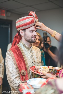 Red mark applied on Indian groom's forehead. Red mark applied on Indian groom's forehead.