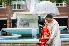 Indian groom kissing Indian bride on their wedding ceremony outfits. Indian groom kissing Indian bride on their wedding ceremony outfits.