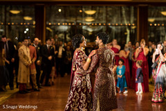Guests observe as the Indian newlyweds have their first dance Guests observe as the Indian newlyweds have their first dance