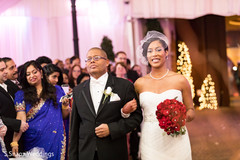 Glamorous Indian bride walking in with parent. Glamorous Indian bride walking in with parent.