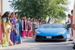 Guests observe the nice ride coming to the ceremony Guests observe the nice ride coming to the ceremony