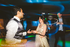 Indian bride dancing with Indian groom at reception Indian bride dancing with Indian groom at reception