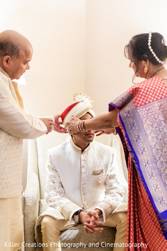 Indian groom being assisted by special guests Indian groom being assisted by special guests