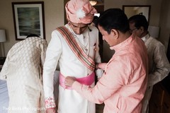 Indian groom being assisted by family Indian groom being assisted by family