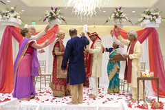 Indian wedding parents throwing rose petals at ceremony. Indian wedding parents throwing rose petals at ceremony.