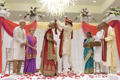 Indian groom putting flower garland to bride. Indian groom putting flower garland to bride.