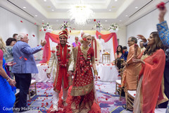 Joyful Indian bride and groom walking out from wedding ceremony. Joyful Indian bride and groom walking out from wedding ceremony.