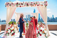 Indian groom putting flower garland to bride. Indian groom putting flower garland to bride.