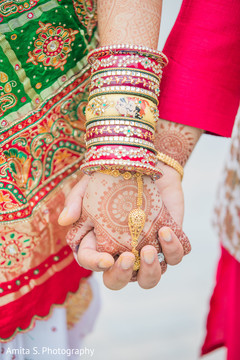 Close up capture of Indian bride and groom holding hands. Close up capture of Indian bride and groom holding hands.