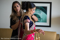 Indian bride being helped to get ready. Indian bride being helped to get ready.