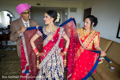 Indian bride being helped by parents to get ready. Indian bride being helped by parents to get ready.