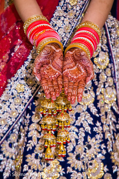 Lovely Indian bride showing her henna art on her hands. Lovely Indian bride showing her henna art on her hands.