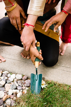 Indian bride and groom holding shovel for Indian pre-wedding ritual. Indian bride and groom holding shovel for Indian pre-wedding ritual.