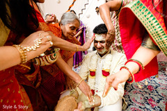 Indian groom getting the turmeric paste on his face. Indian groom getting the turmeric paste on his face.