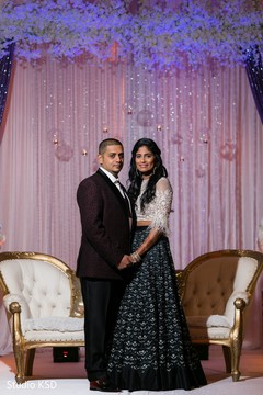 Indian newlyweds posing with their reception attires Indian newlyweds posing with their reception attires