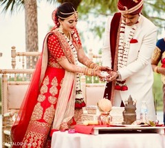 Indian bride and groom throwing the rice together in to fire. Indian bride and groom throwing the rice together in to fire.