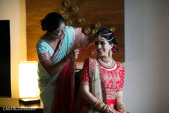 Indian bride getting help to put her wedding Ghoonghat veil on. Indian bride getting help to put her wedding Ghoonghat veil on.