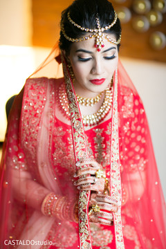Indian bride with her traditional red Ghoonghat. Indian bride with her traditional red Ghoonghat.