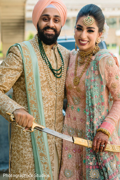 Indian bride and groom holding the kirpan Indian bride and groom holding the kirpan
