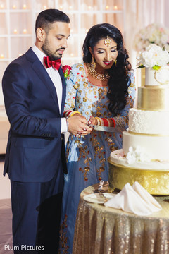 Lovely capture Indian bride and groom cutting cake together. Lovely capture Indian bride and groom cutting cake together.
