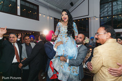 Indian bride being lifted up by groomsmen. Indian bride being lifted up by groomsmen.