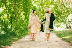 Dazzling Indian bride and groom walking holding hands. Dazzling Indian bride and groom walking holding hands.